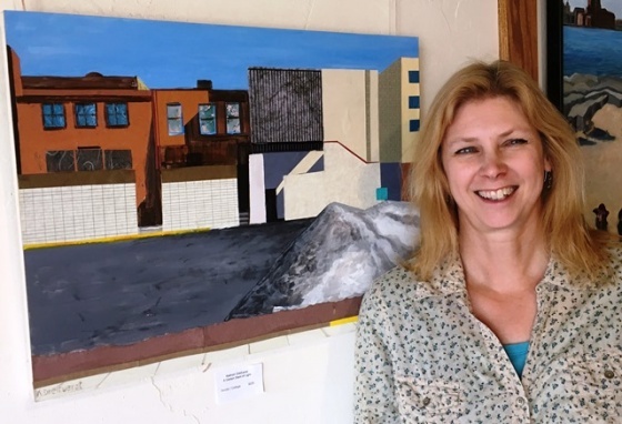 Kathryn Dreifuerst is pictured with her mixed-media piece, A Certain Slant of Light, which was inspired by a line from a poem by Emily Dickinson.